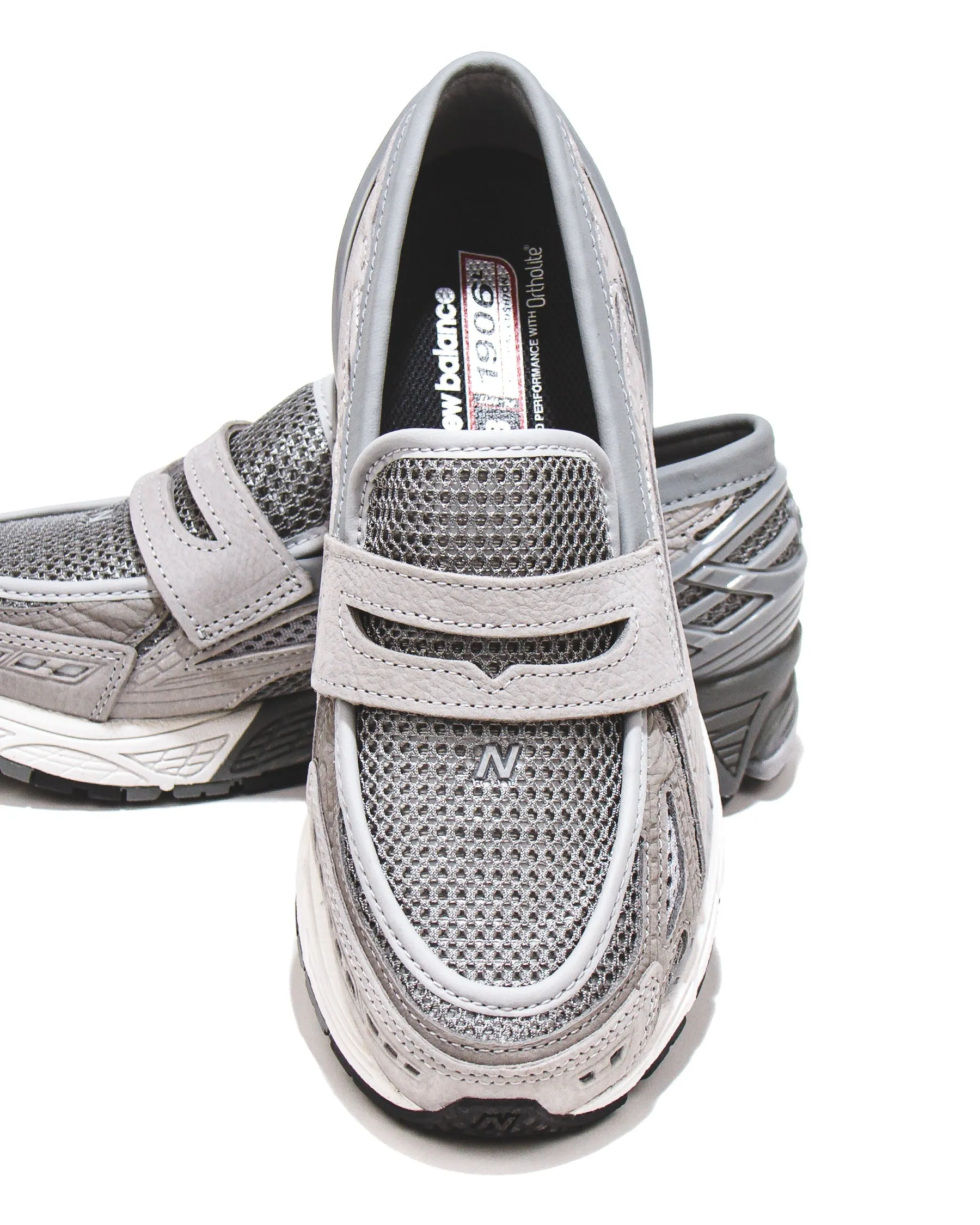 New Balance Unisex 1906L Raincloud Slate Grey U1906LGR classic accessory running in a monorail station area shoes
